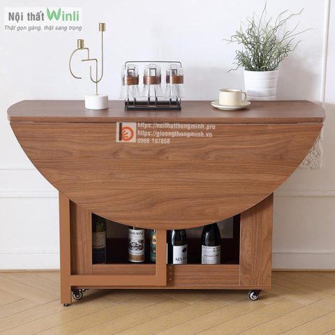 Bàn ăn tròn gấp gỗ tự nhiên màu nâu đang mở một mặt, phù hợp cho không gian nhỏ.
