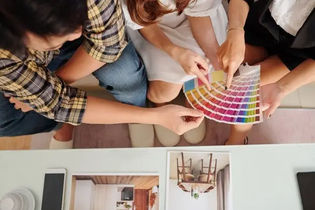 Young-couple-discussing-wall-color-new-apartment-with-interior-designer-top-view_274689-18753.jpg