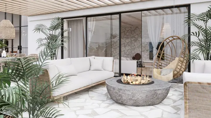 Một chiếc gương thủ công tô điểm cho khu vực phía trên một đơn vị vanity bê tông trắng.